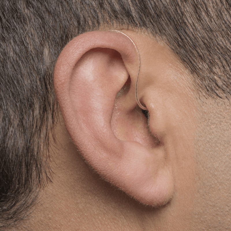 A person's ear with Phonak Audeo 50 / 90 hearing aids with invisible dome